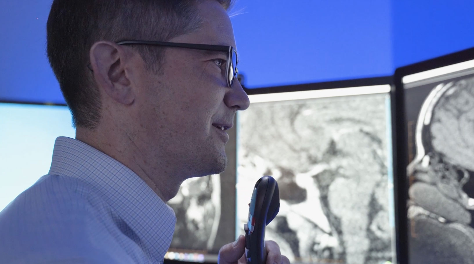 Group of radiologists viewing an image on a computer monitor